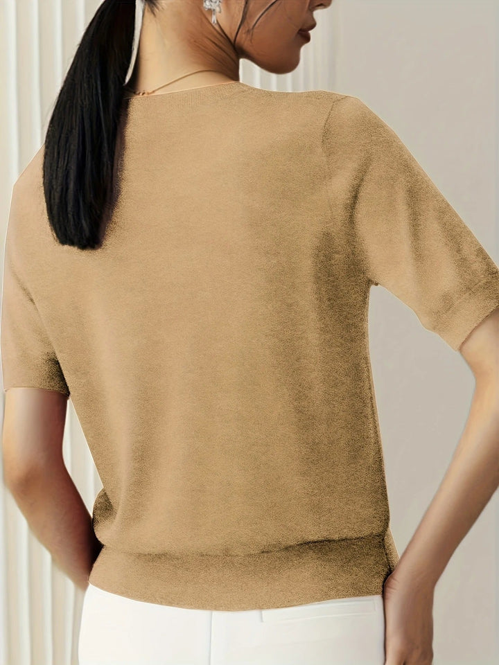Stylish women's short sleeve top featuring a crew neck and ribbed hem.
