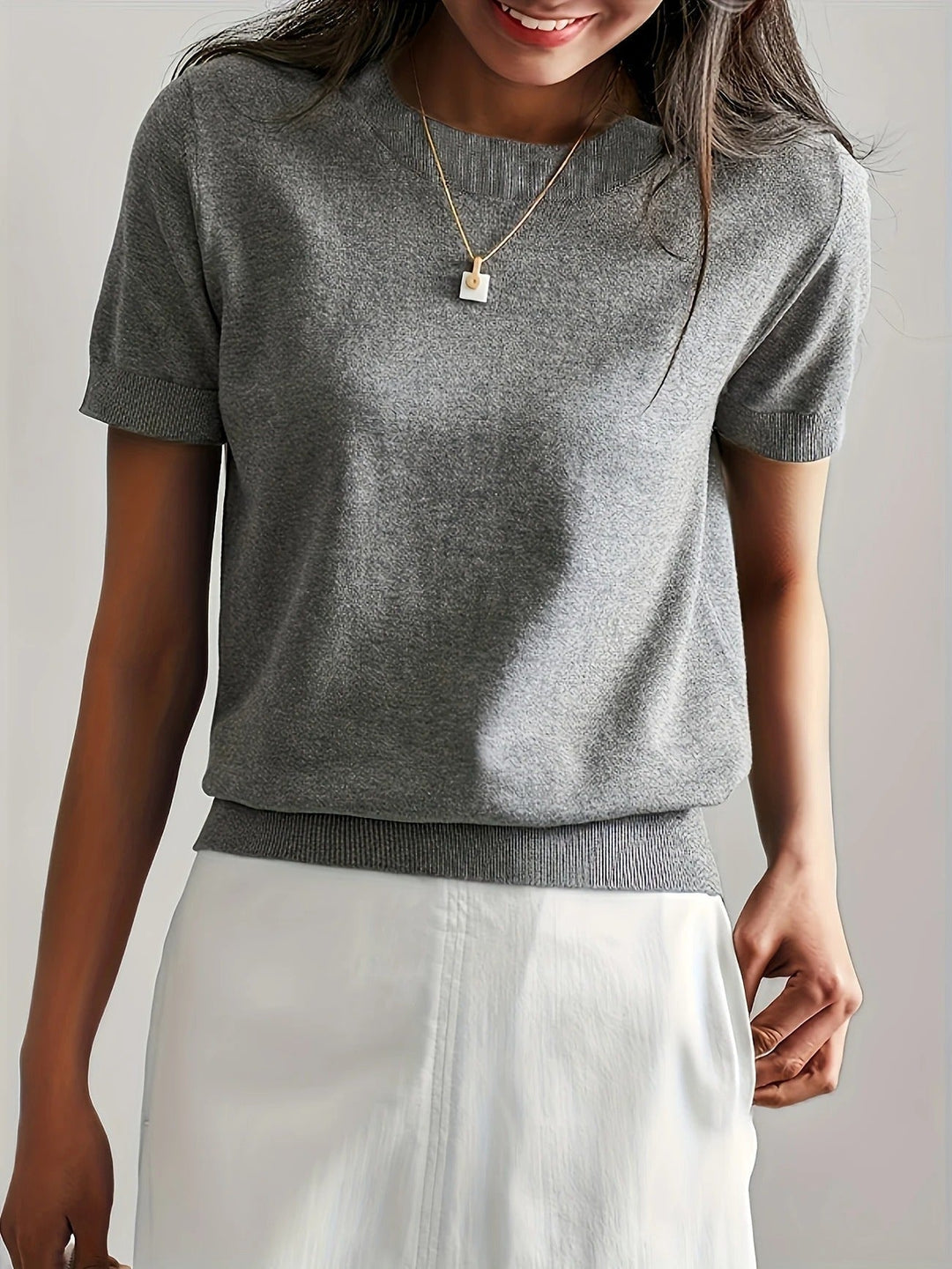 Relaxed fit women's crew neck short sleeve top. Versatile for daily wear.