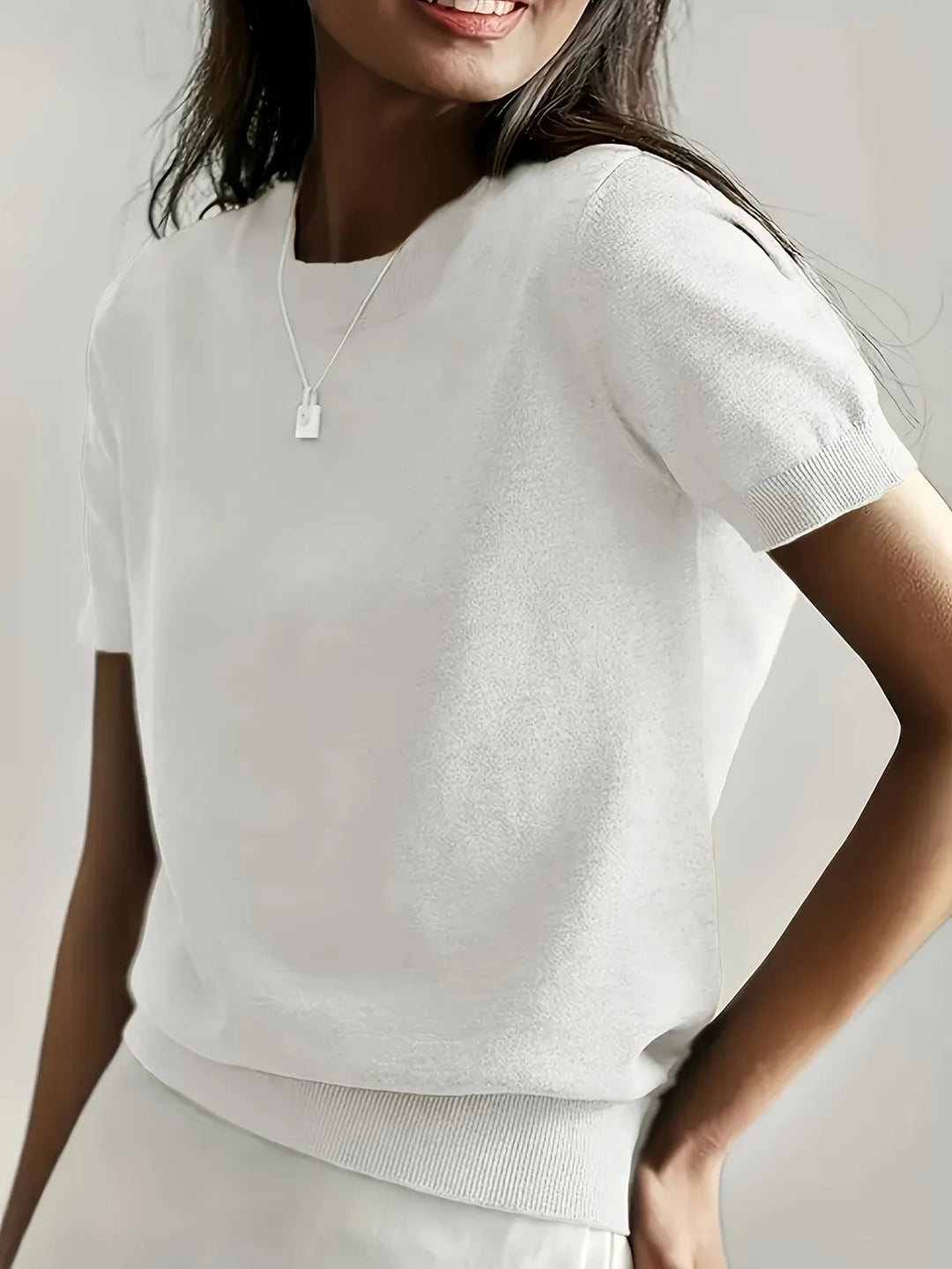 Women's versatile short sleeve top. Classic crew neck and stylish ribbed hem.