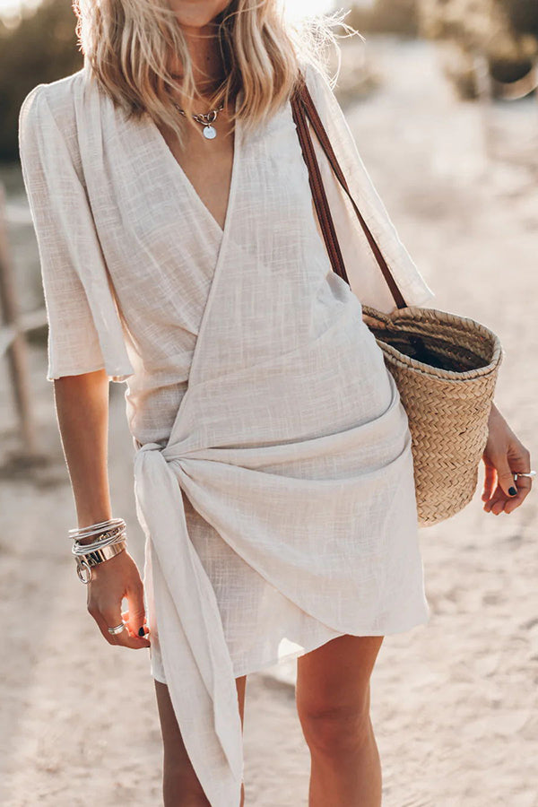 Women's short sleeve V-neck wrap mini dress with tie waist. Ideal for summer fashion & casual wear.