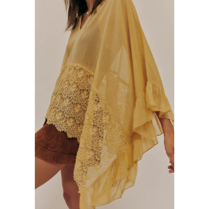 Model wearing Women's Siena sheer lace poncho top over a camisole, elegant summer style.