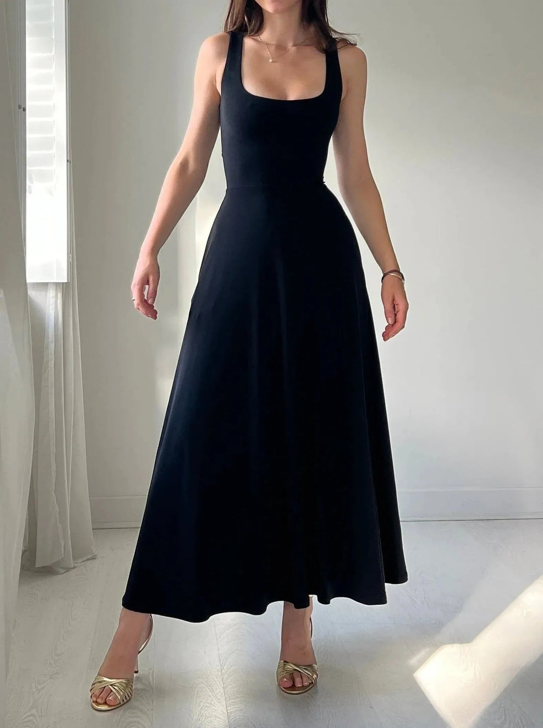 Women's sleeveless A-line midi dress. Effortless, elegant style with a flattering fit, perfect for summer.