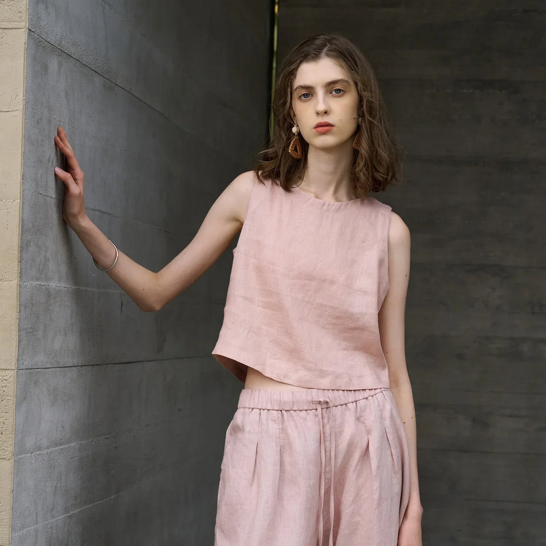 Women's sleeveless asymmetric crop top with crew neck. Ideal for summer casual wear & modern style.