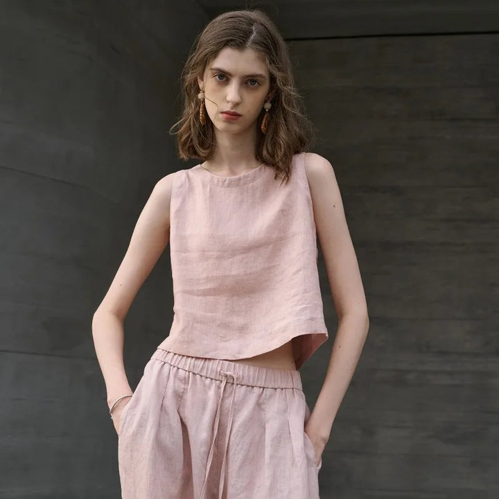 Trendy women's asymmetric crop top, sleeveless with crew neck. Perfect for modern summer fashion.
