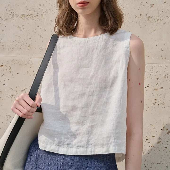 Vacation-ready women's sleeveless asymmetric crop top, crew neck. Light & breathable summer style.