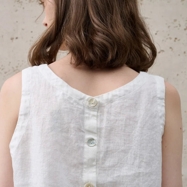 Versatile women's sleeveless crop top, asymmetric design & crew neck. Chic for trendy daily outfits.
