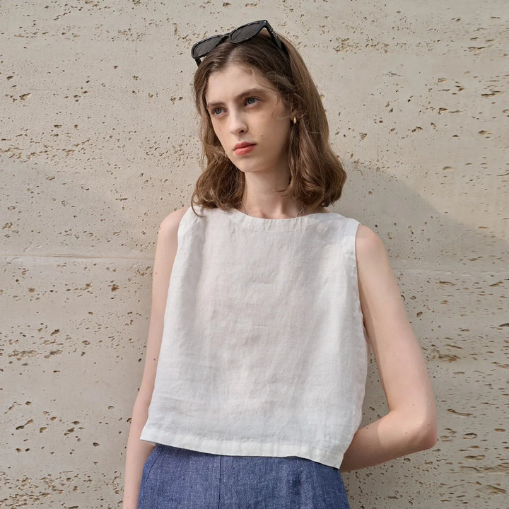 Women's sleeveless asymmetric crew neck crop top. Your go-to for comfortable, modern summer fashion.