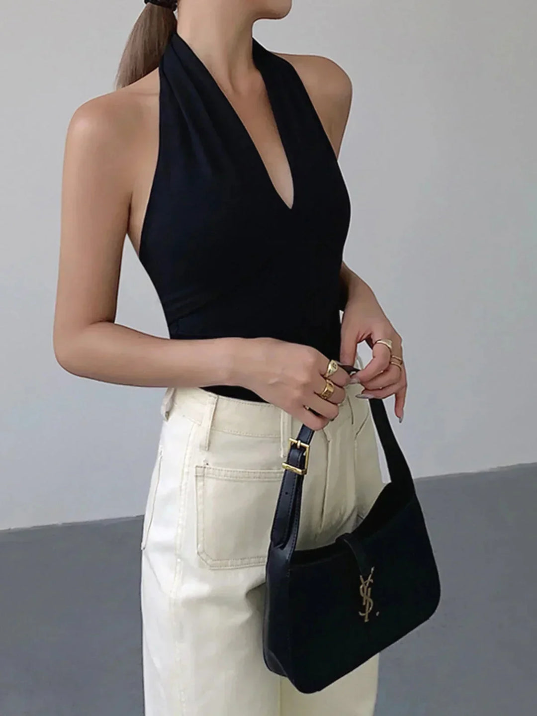 Black women's sleeveless halter top, crossover V-neck for versatile casual & daily fashion.