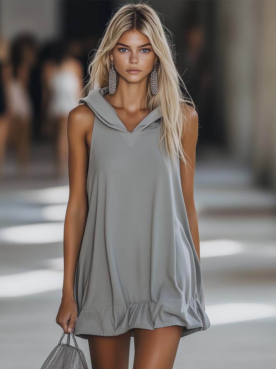 Women's sleeveless hooded mini dress with playful ruffle hem. Perfect casual summer fashion.