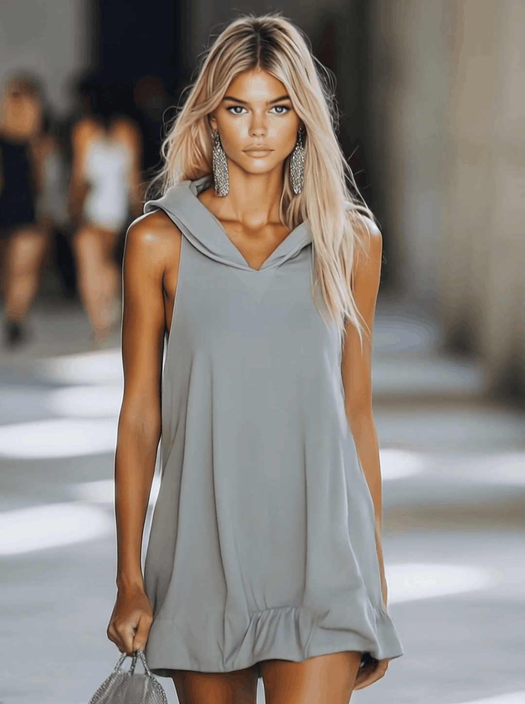 Relaxed fit A-line sleeveless mini dress with hood & ruffle hem. Versatile casual women's apparel.