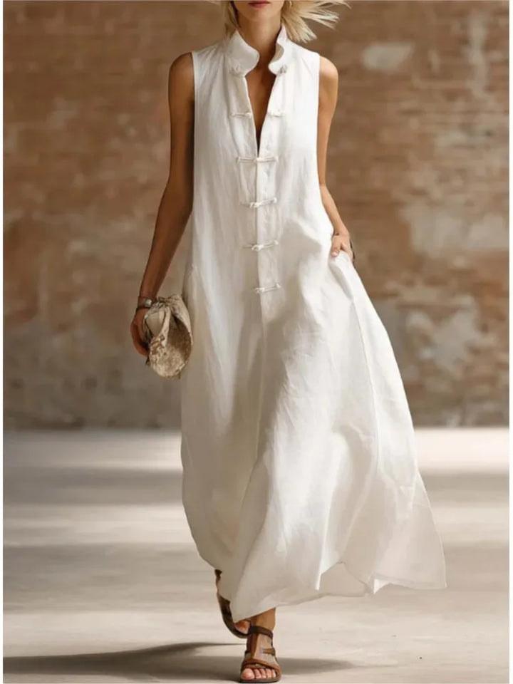 Elegant women's collared sleeveless maxi shirt dress. Flowy design for comfortable casual or vacation fashion.