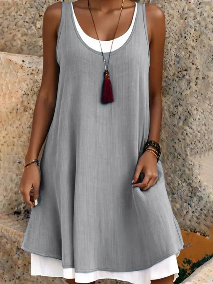 Elegant women's sleeveless scoop-neck A-line dress featuring a unique two-layer design for a stylish layered look.
