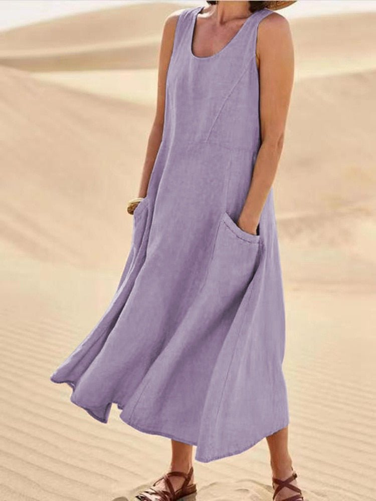 Chic sleeveless scoop-neck midi dress for women, featuring practical pockets. Great for beach outfits & summer.