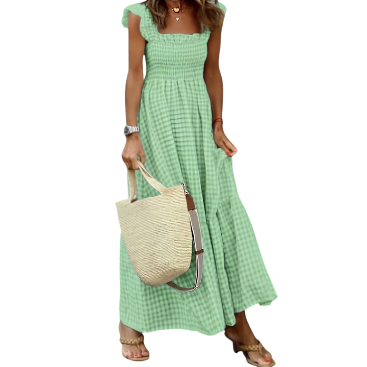 Stylish women's flowy maxi dress with smocked top and tiered skirt, offering comfortable, elegant summer fashion.