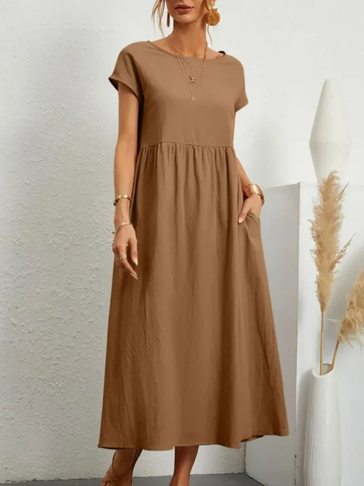 Casual summer maxi dress with smocked waist and short sleeves, great for beach or everyday comfort.