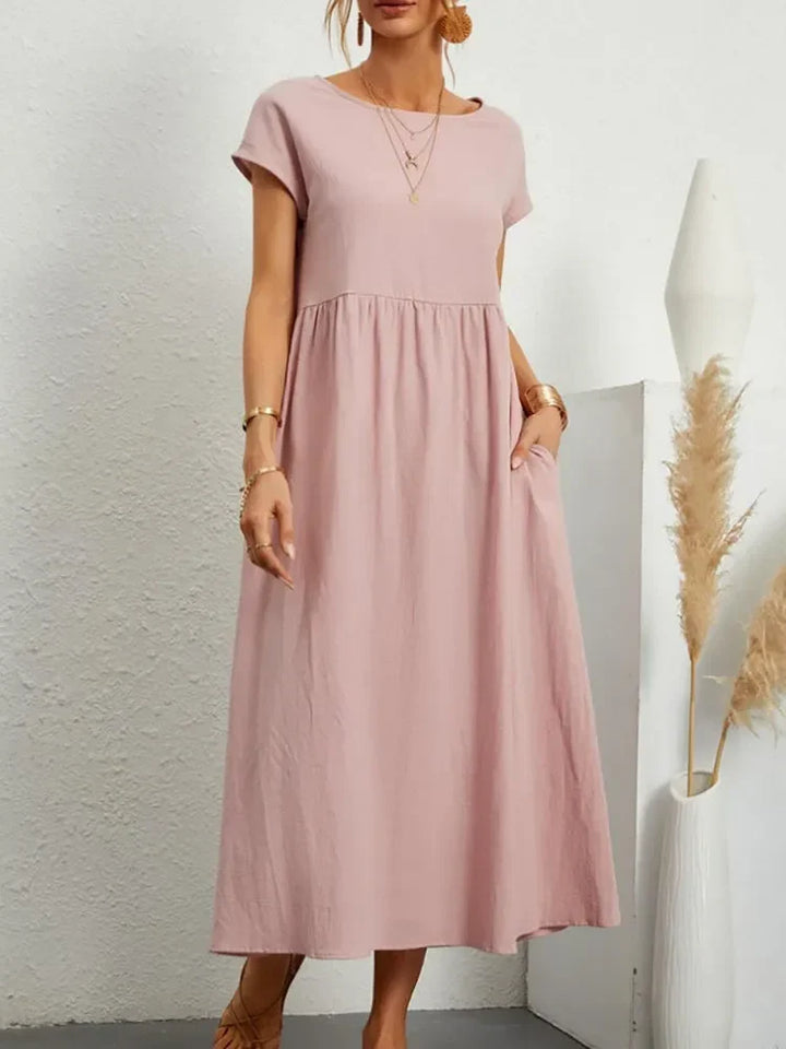 Flowy, comfortable women's short sleeve maxi dress with smocked waist, perfect for warm weather.