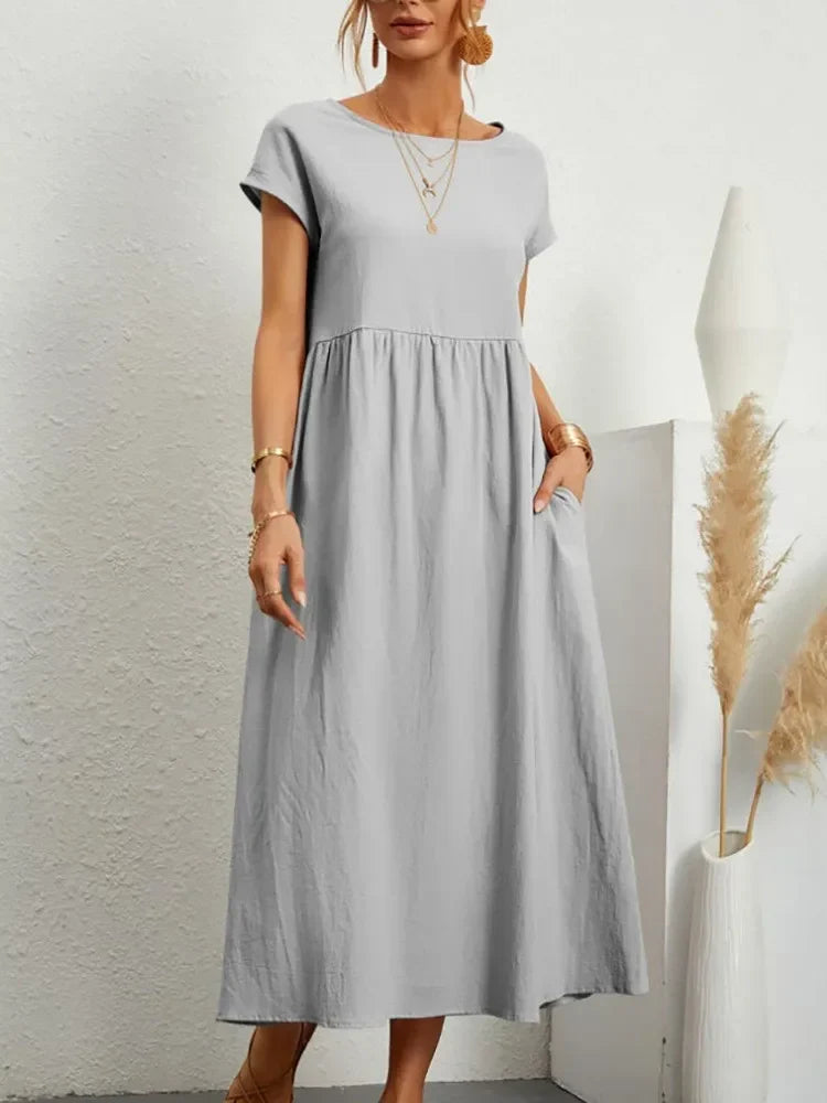 Stylish women's smocked waist short sleeve A-line maxi dress, versatile for casual occasions.