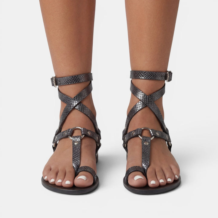 Trendy women's python print flat sandals with buckled straps, versatile for summer outfits.