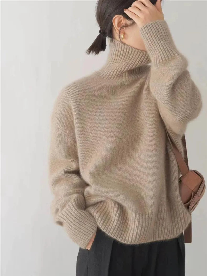Stylish woman wearing a comfortable, lightweight cashmere funnel neck sweater in a neutral hue
