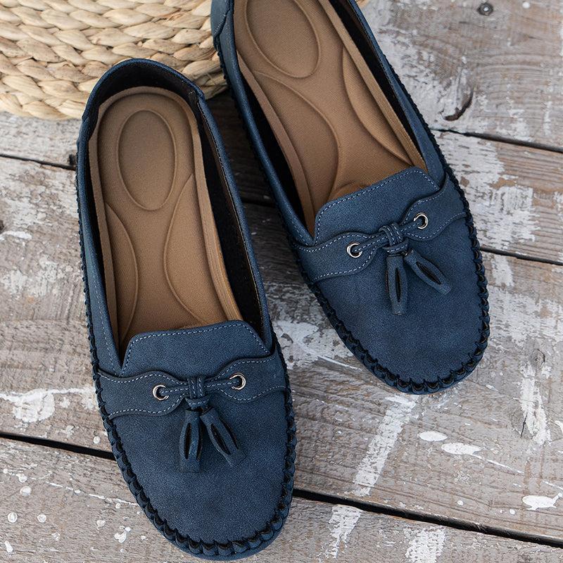 Tan women's flat loafers with a flexible sole for comfortable everyday wear.