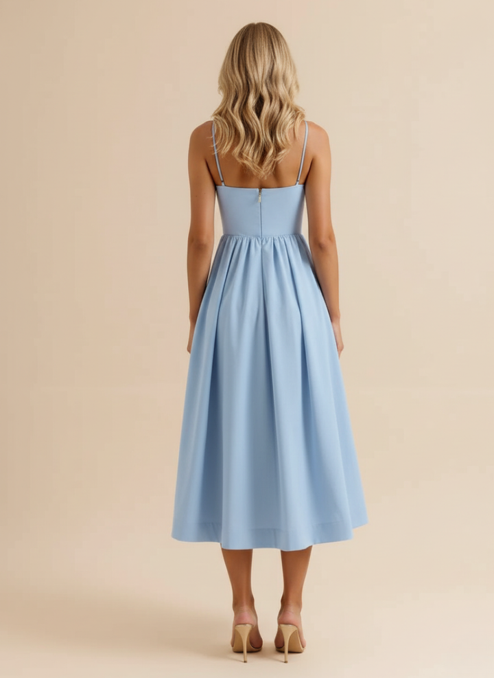 A-line silhouette women's midi dress with spaghetti straps and scoop neck. Ideal for summer elegance.