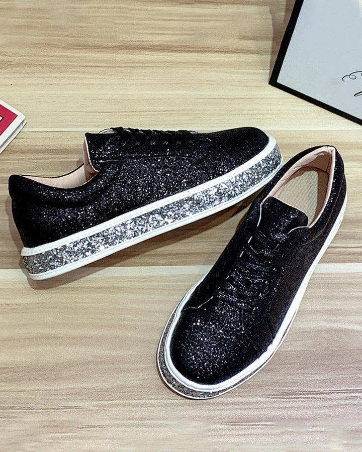 Black glitter platform women's sneakers. Chic casual footwear with a trendy design for comfortable everyday style.