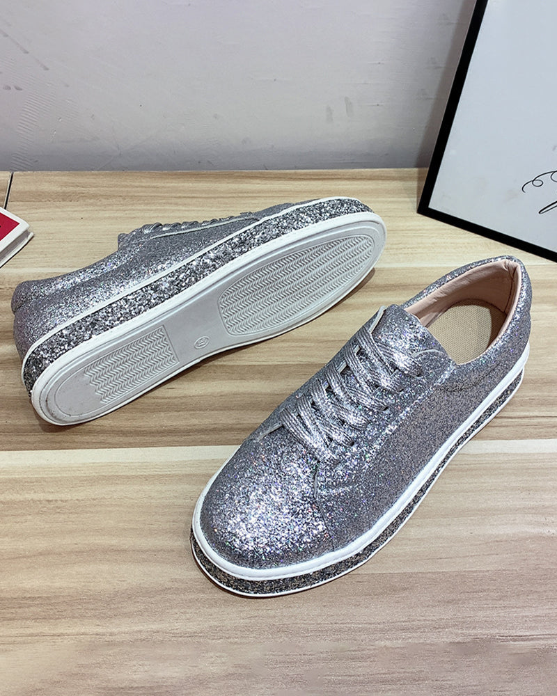 Stylish women's glitter platform sneakers, showcasing sparkling detail. Chic casual footwear for trendy ladies.