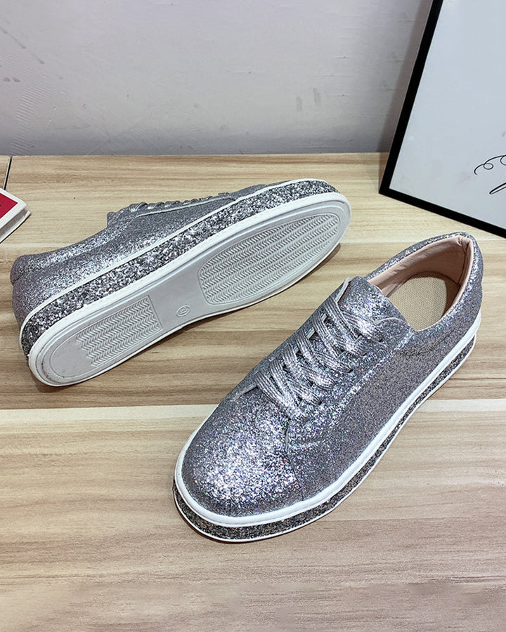Stylish women's glitter platform sneakers, showcasing sparkling detail. Chic casual footwear for trendy ladies.