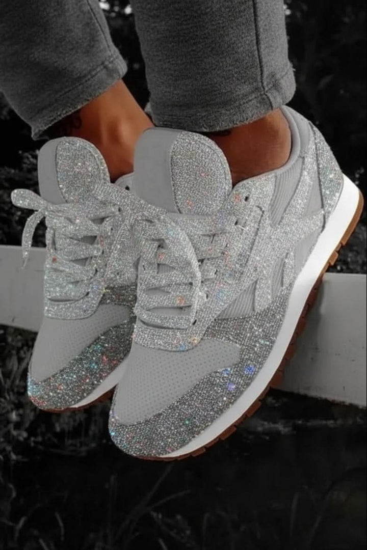 Relaxed shot of women's sparkling glitter sneakers, perfect for comfortable yet fashionable casual wear.