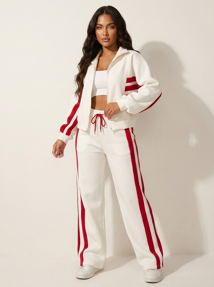 Athleisure women's two-piece tracksuit. Features zip-up jacket & wide-leg pants with stylish contrast stripes.
