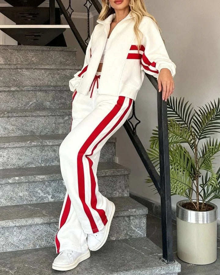 Casual women's athleisure tracksuit set. Zip-up jacket & wide-leg pants with trendy contrast stripe design.