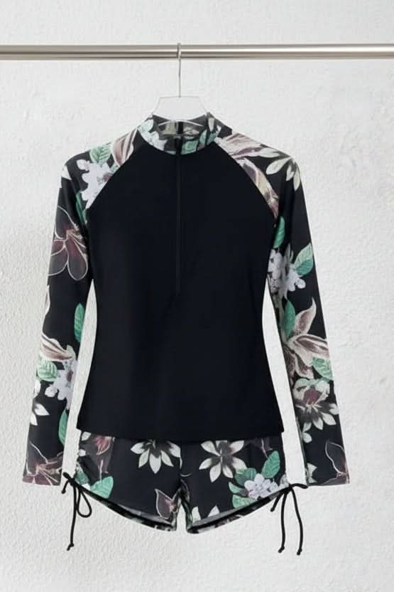 Active women's tropical rashguard swimsuit, long sleeve top & high-waisted bottom for sporty beach & pool days.