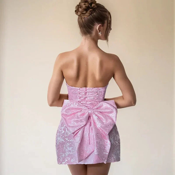 Women's elegant strapless mini cocktail dress with a sophisticated bow back. Perfect for chic event style.