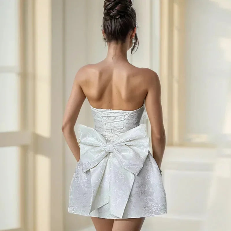 Stylish women's strapless mini dress, a perfect summer party dress with an eye-catching statement bow back.