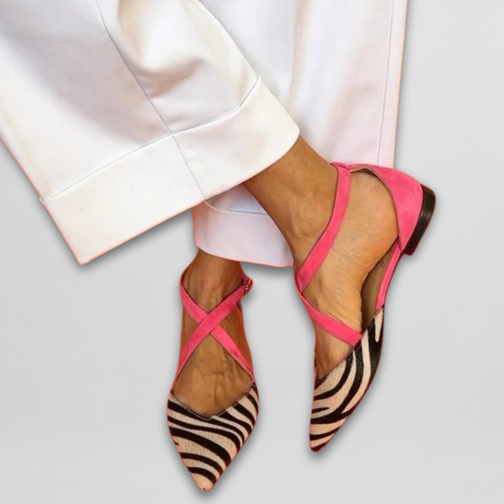 Women's strappy ballerina flats with bold zebra print & vibrant fuchsia accents, perfect for unique summer style.