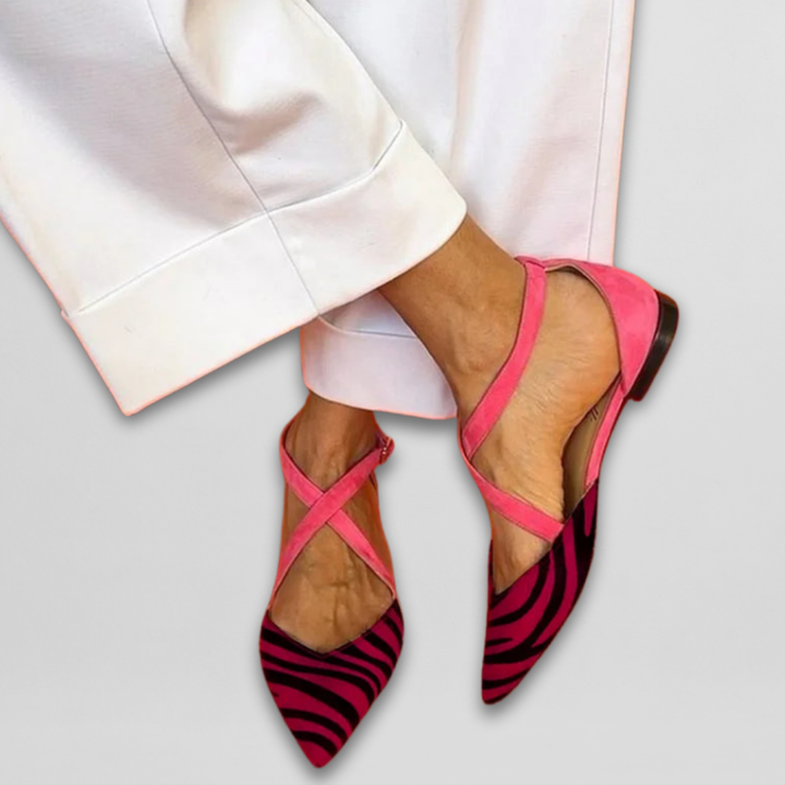 Colorful women's ballerina flats featuring striking zebra print & bright fuchsia straps for a playful look.