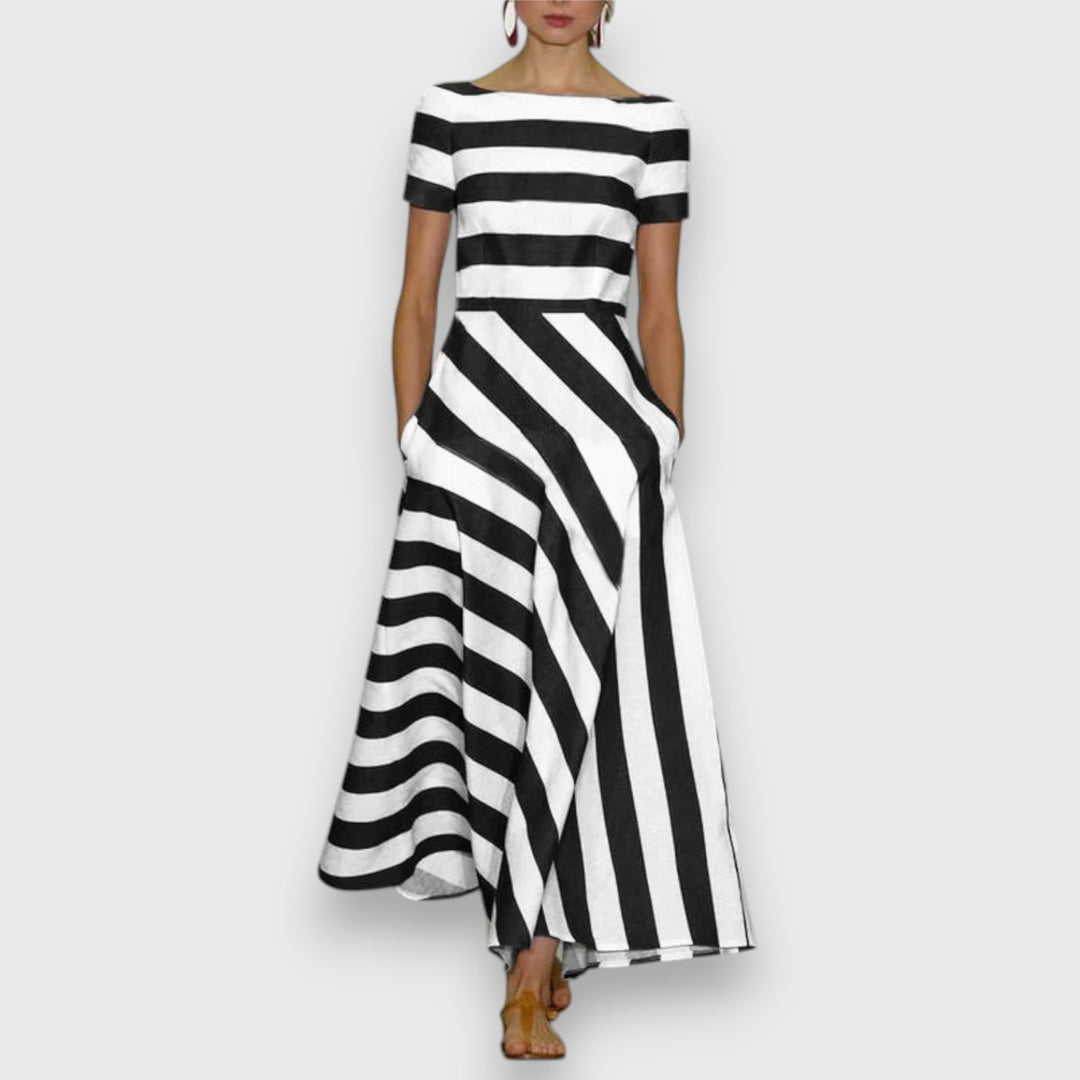 Chic women's short-sleeve striped maxi dress featuring a classic bateau neck and convenient side pockets. Nautical fashion.
