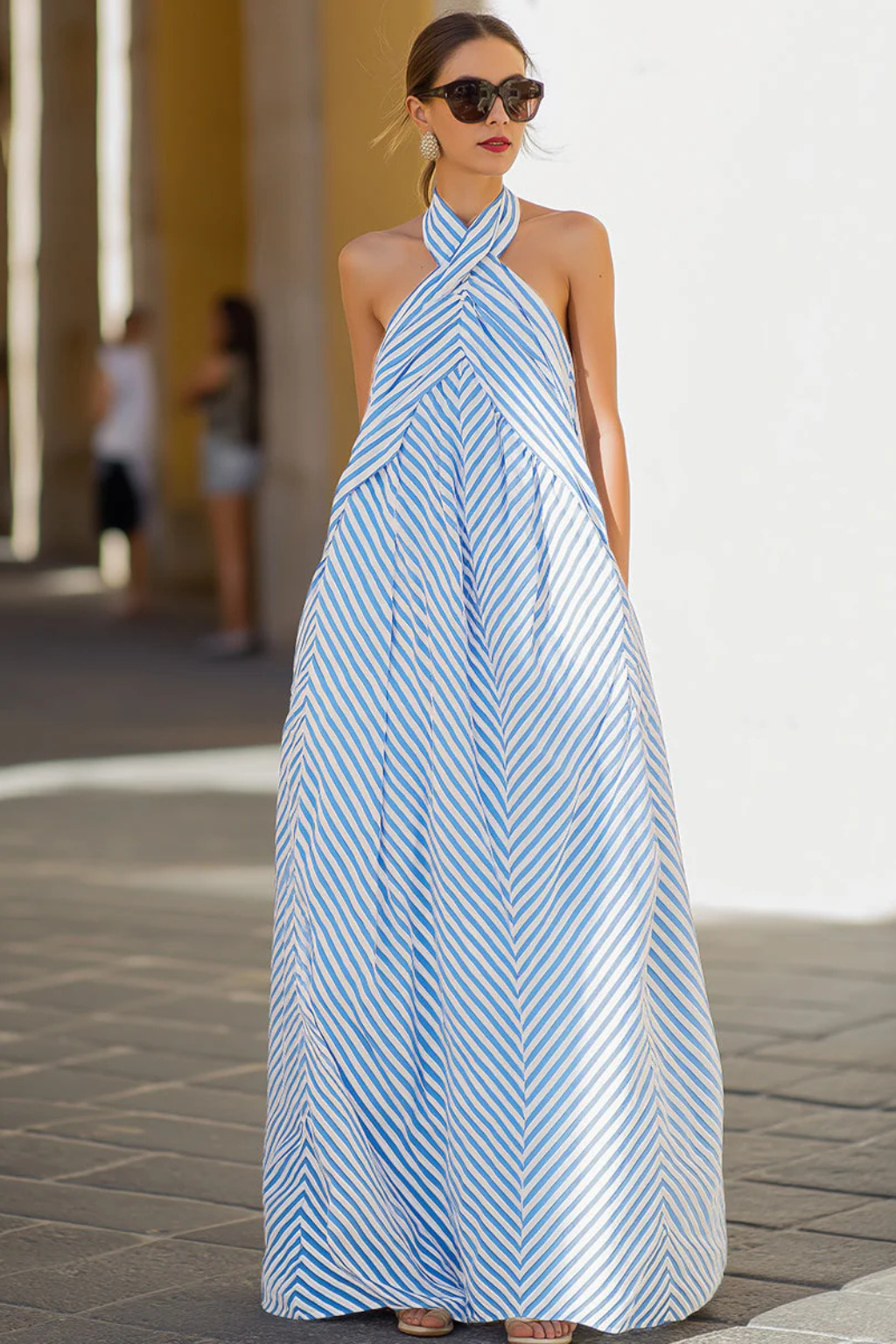 Striped women's maxi dress with a halter neck design, offering a relaxed and flowing summer style.
