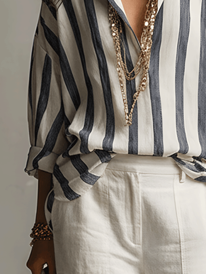 Back view of a women's striped long sleeve blouse, showcasing its relaxed drape and flowy style.