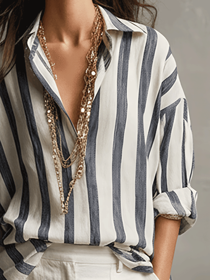 Close-up of the button front detail on a women's striped long sleeve blouse, emphasizing quality.