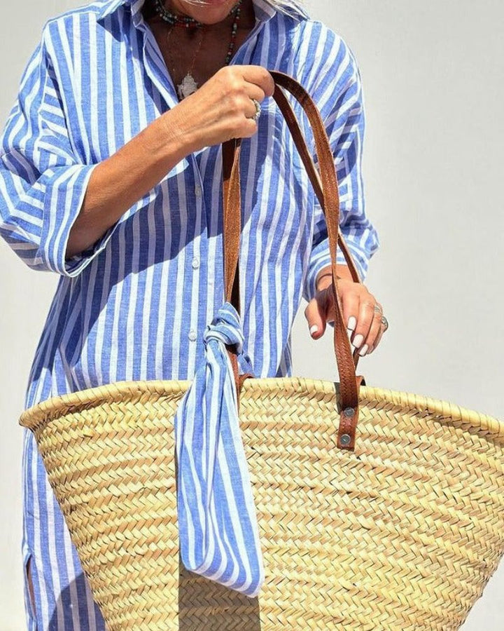 Stylish women's striped button-down midi dress, a chic and casual summer fashion staple with pockets.