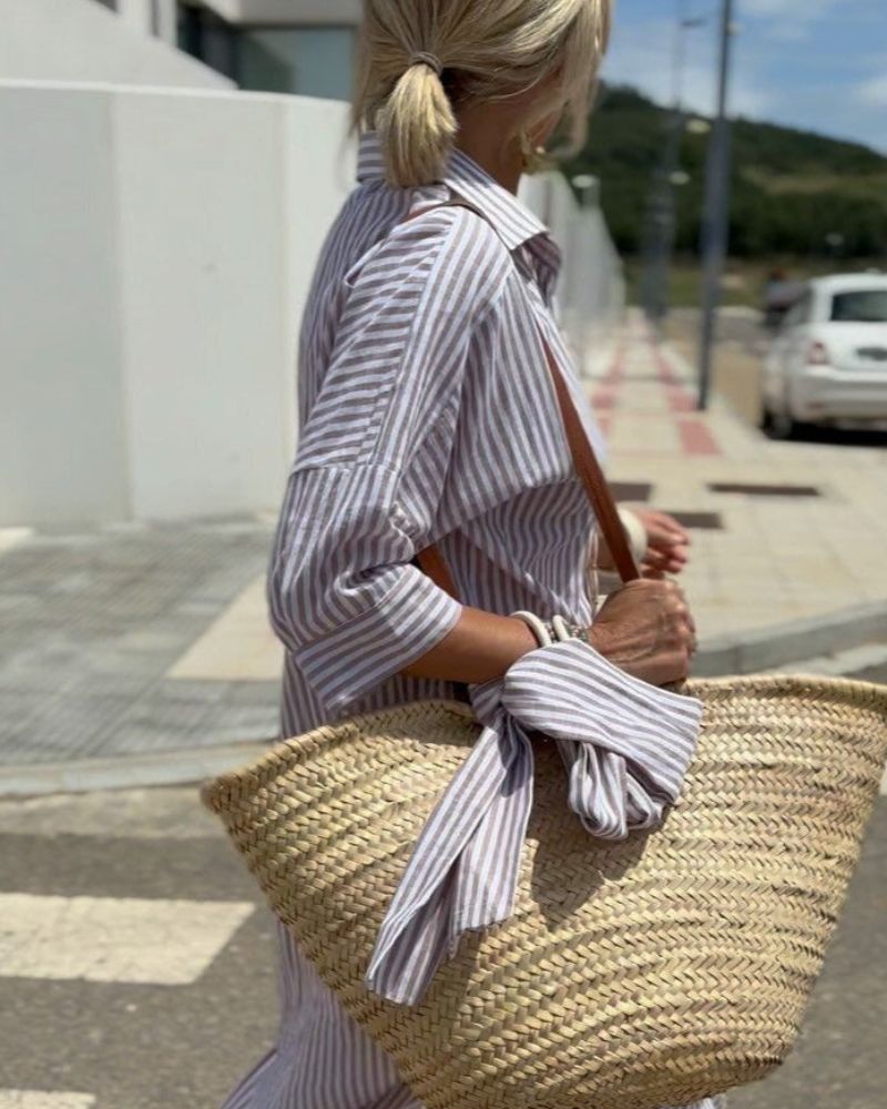 Versatile women's striped shirt midi dress, button closure, and side pockets. Ideal for everyday elegance.