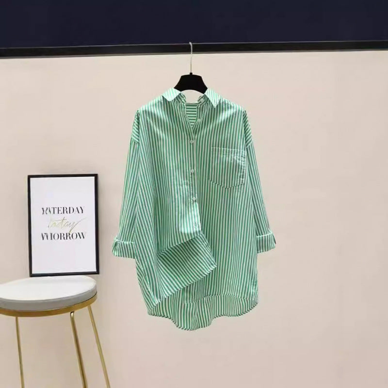 Stylish women's striped oversized button-down shirt, longline design, versatile for preppy and casual looks.