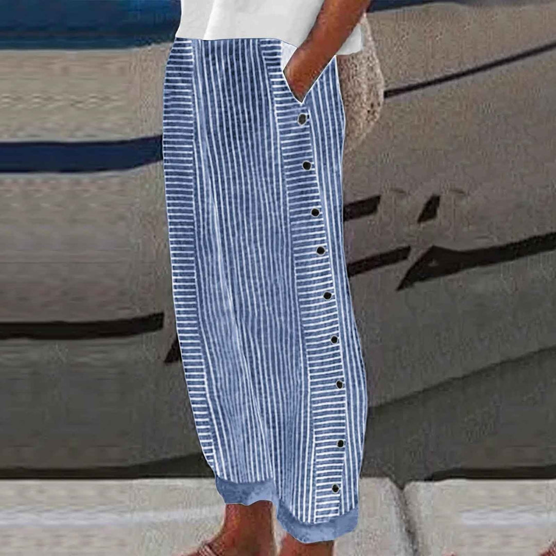 Chic women's striped pants with unique button accents. Relaxed fit offers versatile, comfortable everyday fashion.