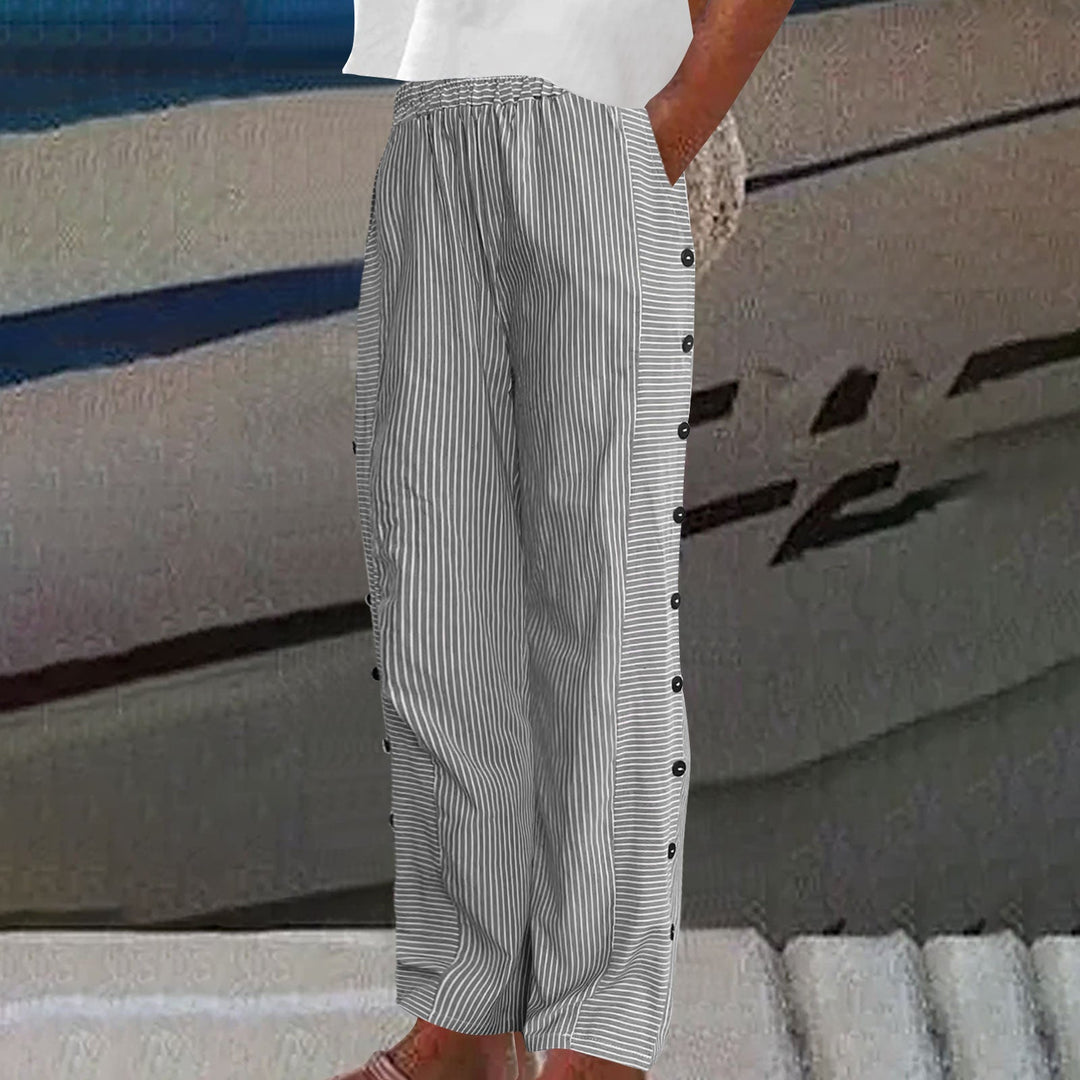 Detailed view of women's striped pants, highlighting stylish button accents & comfortable relaxed fit.