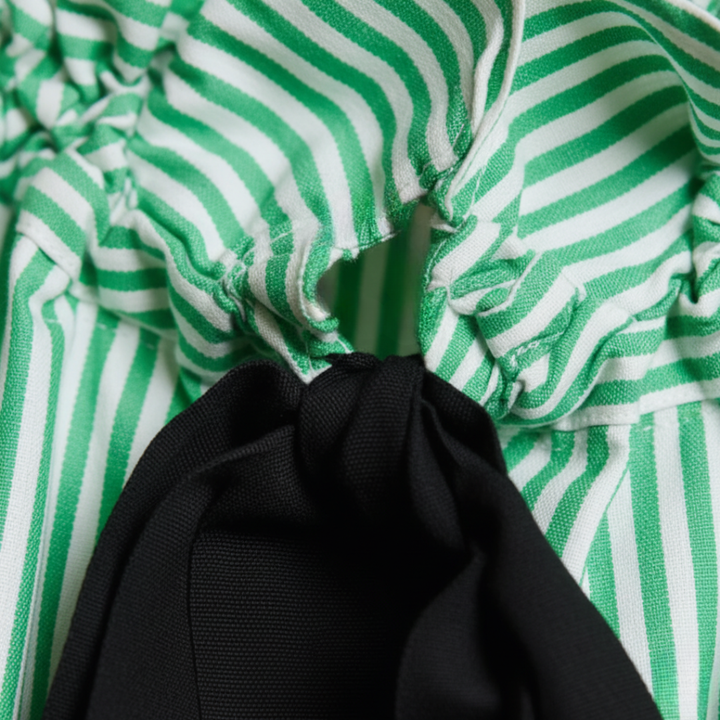 Elegant long sleeve striped blouse for women, with a delicate ruffle front and stylish bow tie neckline.