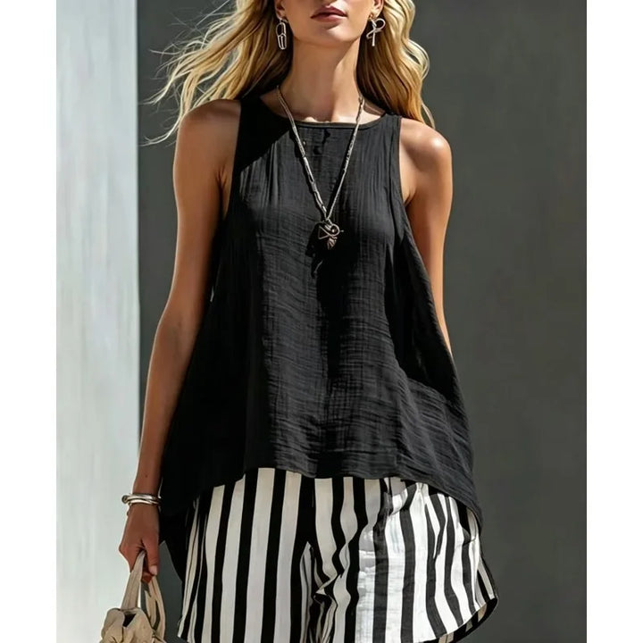Model wears a women's striped tank top and shorts summer set, showcasing a trendy and relaxed two-piece outfit.