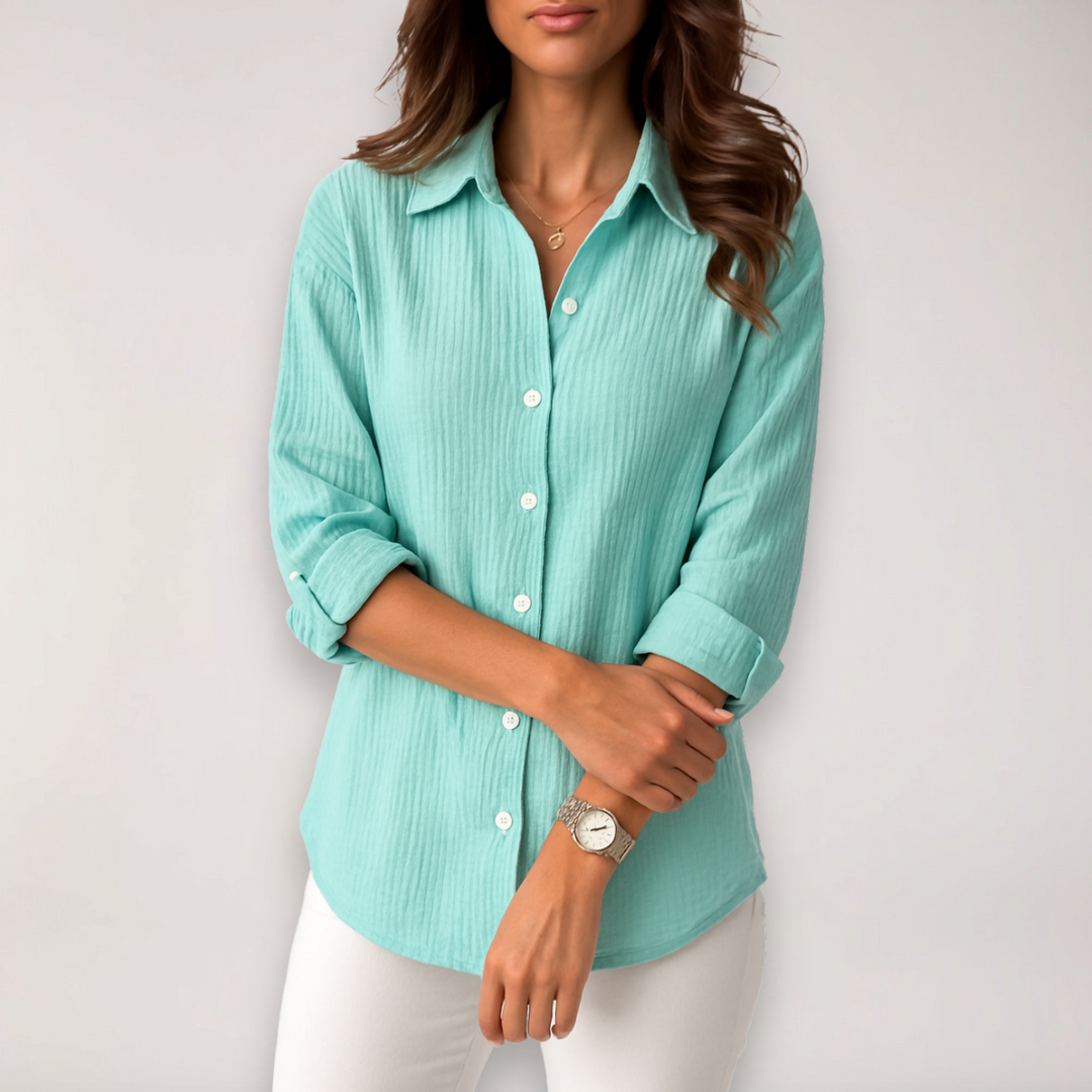 Versatile women's button-up shirt featuring roll-up sleeves, a stylish top for both professional and relaxed wear.