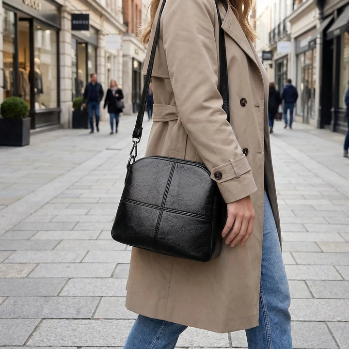 Women's stylish crossbody shoulder bag with unique stitched design. Elegant and versatile mini handbag.