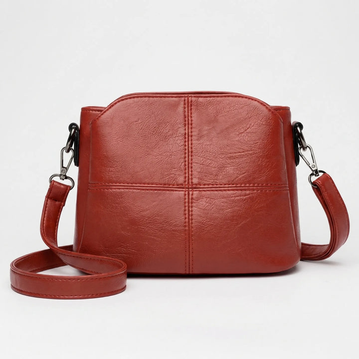 Elegant women's crossbody bag with stitched design & adjustable strap. Perfect daily essential fashion accessory.